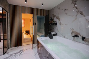 A modern bathroom with a large bathtub, a shower area, and a vanity with a marble countertop. - Premium Smart-Home Spa Residence Near Banja Luka Centre (Banja Luka)