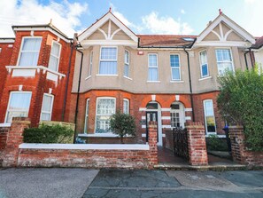 A two-story residential building with a brick facade, multiple windows, and a gated entrance. - Fernleigh (Margate)
