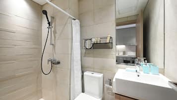 A modern bathroom with a shower, toilet, and sink.