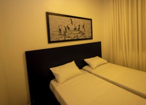 A hotel room with a bed, a headboard, and a framed artwork on the wall. - Adorable 4-bedroom house in Kigali perfect for family stays (Kigali)