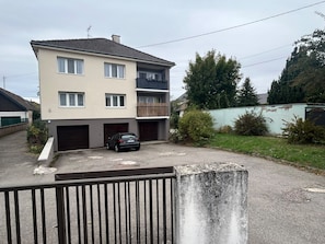 A two-story residential building with a car parked in the driveway. - Vrbo Property (Lingolsheim)