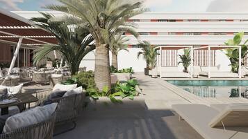 A poolside area with lounge chairs, a dining table set, and a palm tree.