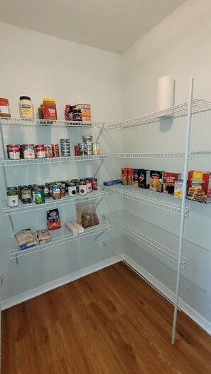 A pantry with multiple shelves stocked with canned goods, jars, and boxes. - Southwest Ocala Retreat | World Equestrian Center (Ocala)
