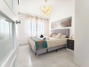 A modern bedroom with a bed, curtains, a painting, a lamp, and a view of the outdoors. - Top Floor 2 Bedroom Apartment with Terrace. Next to City of Arts & Oceanografic (València)