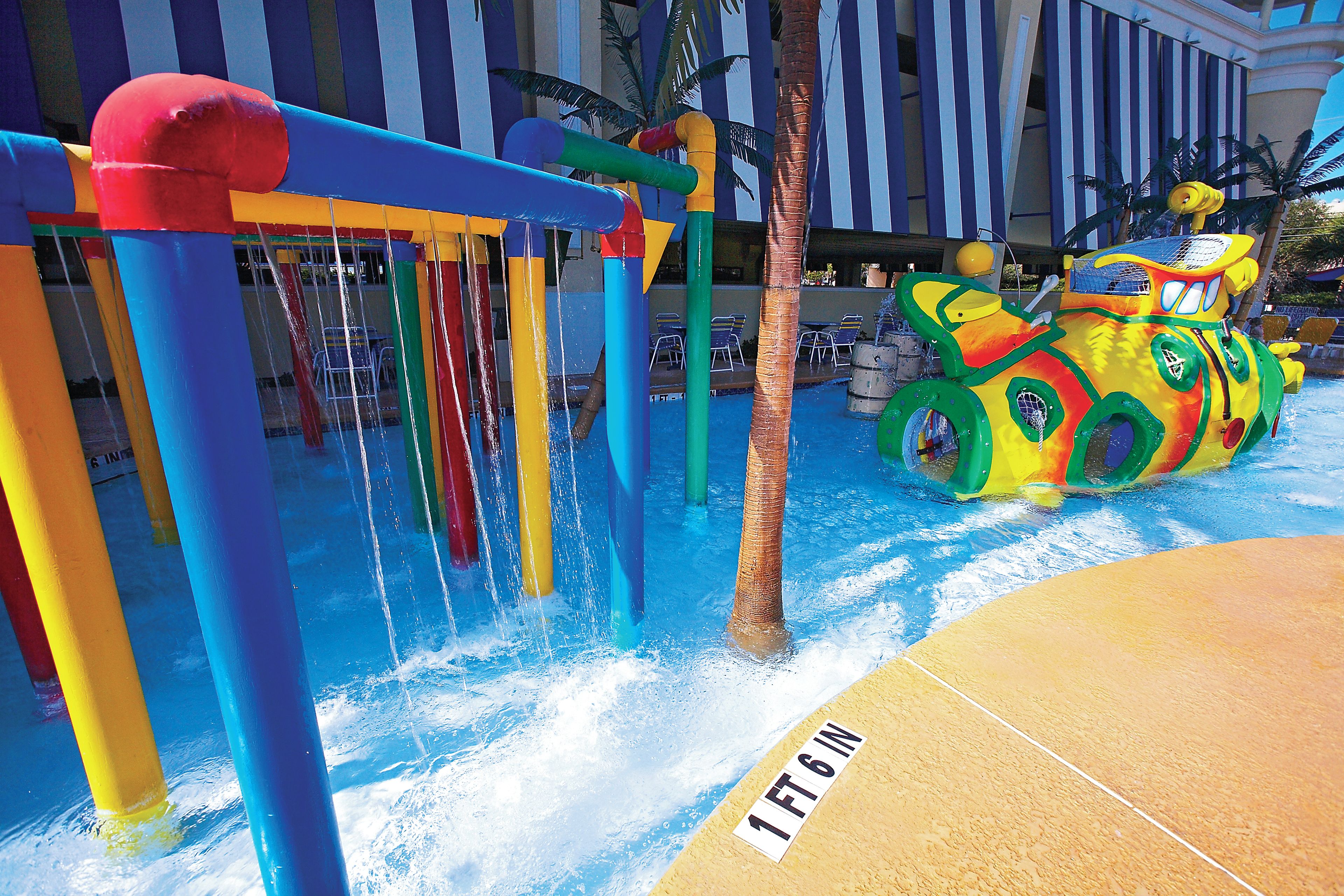 A water play area with a slide and a water jet feature.