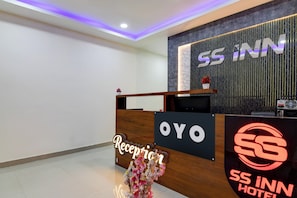 A hotel reception desk with a sign that reads 'SS INN HOTEL'. - Hotel O SS INN (Bhubaneshwar)