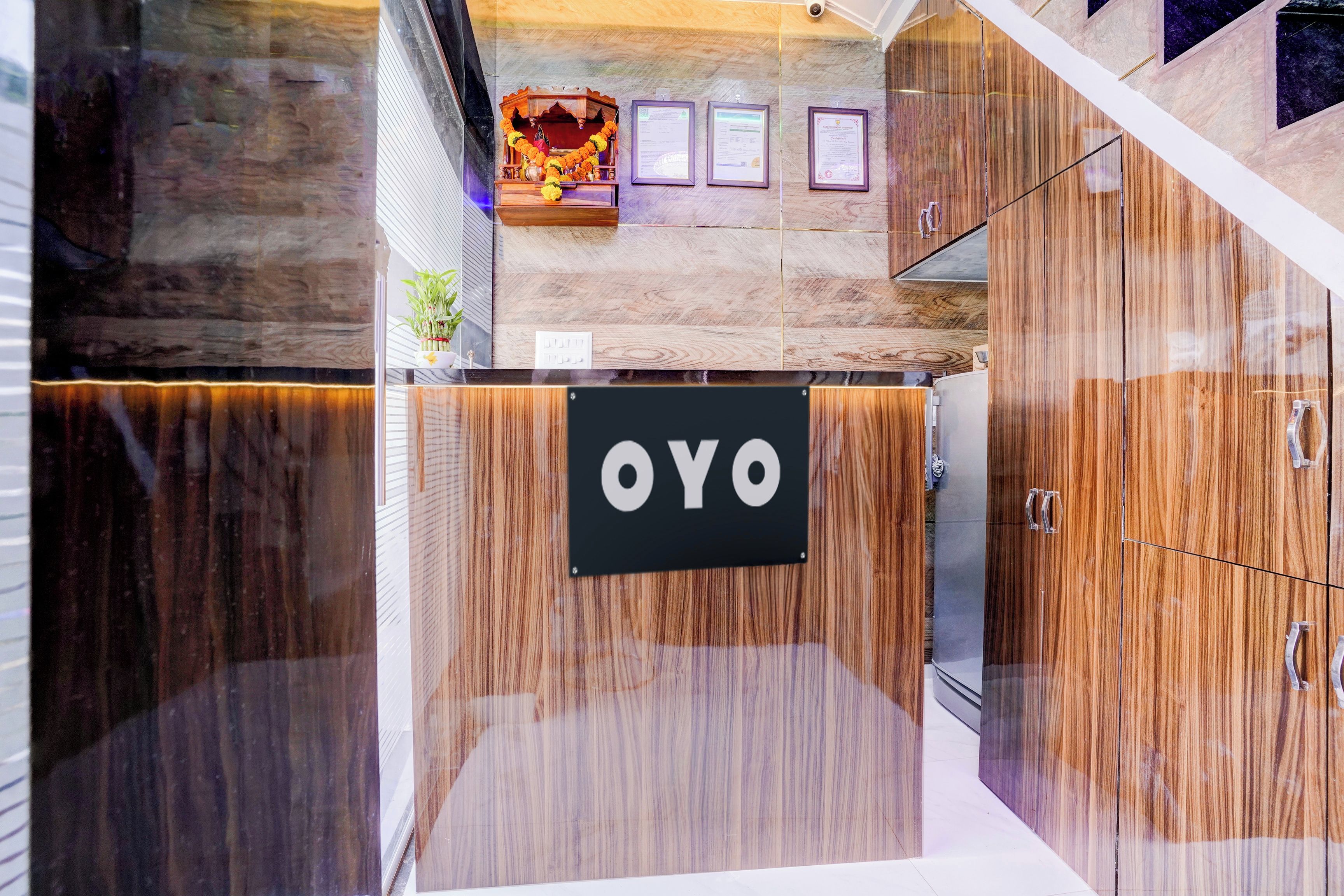 A reception area with a sign that reads 'OYO' and a wall-mounted display case with certificates.