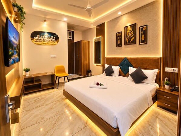 A modern hotel room with a large bed, a desk, and a television. - Raj Rani Complex And Hotel Restaurant (Mainpuri)