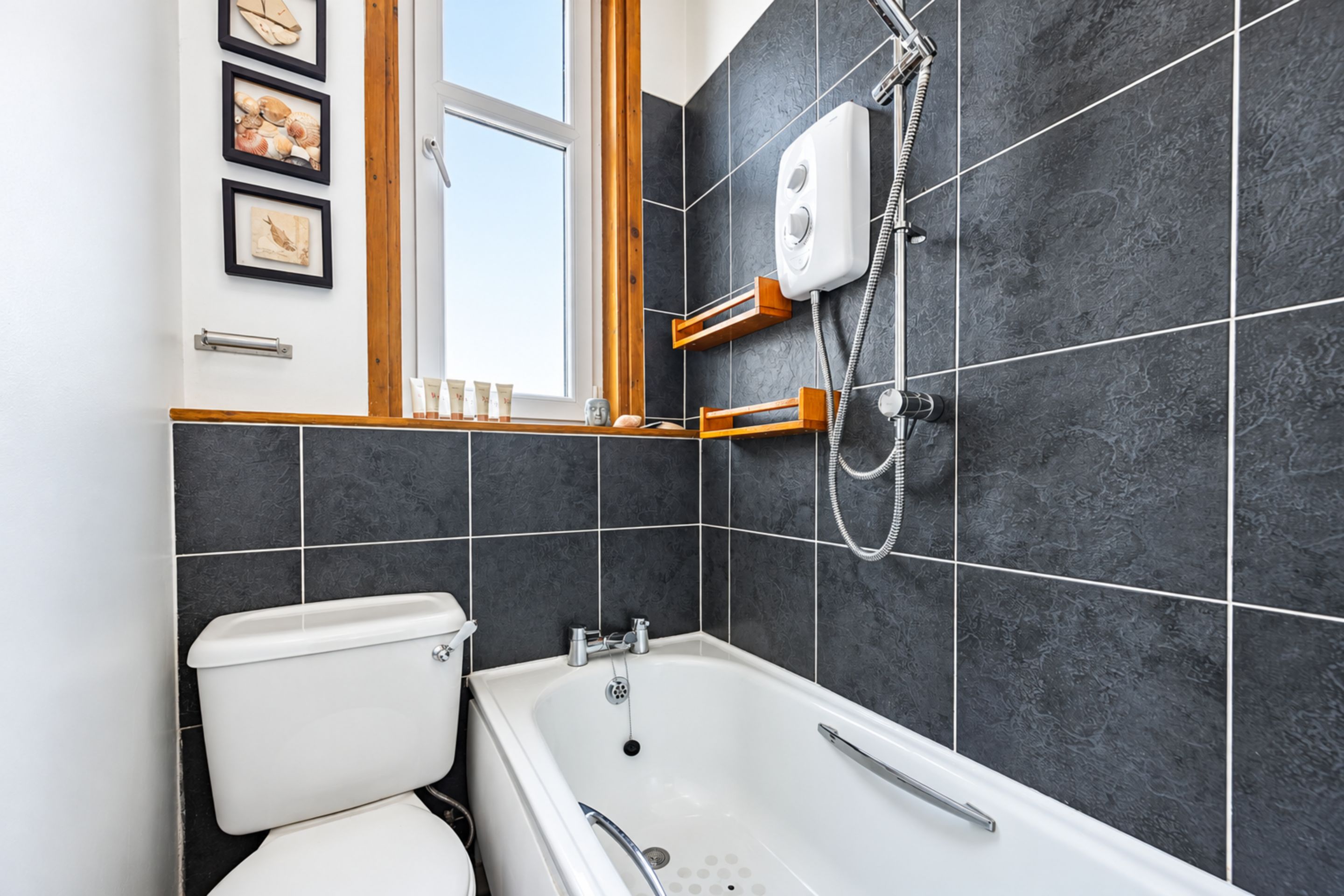 A bathroom with a bathtub, a toilet, and a shower.