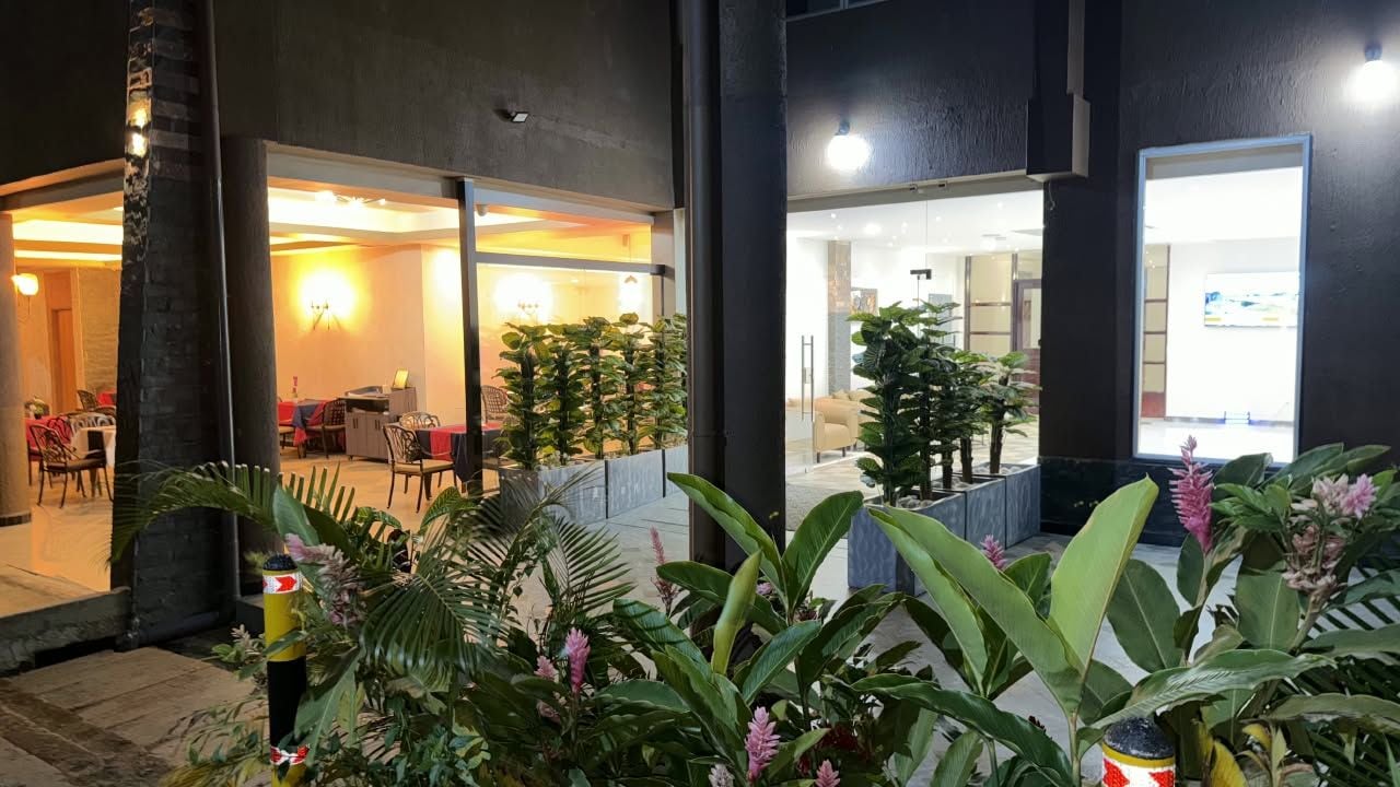 An outdoor area with a seating area and potted plants.