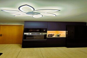 A modern kitchen with a built-in oven, microwave, and refrigerator.
