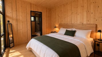 A wooden-paneled bedroom with a bed, bedside lamps, and a large mirror.