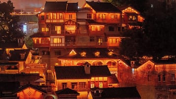 A traditional multi-story building with multiple balconies and a central courtyard.