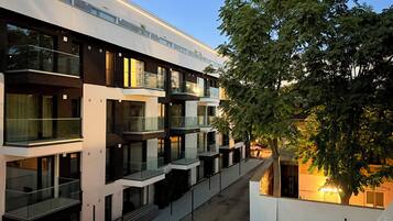 A multi-story building with balconies and large windows.