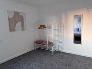 A room with a bunk bed, a small table, and a window. - Spacious 3-Bed Home, Sleeps 8, Large Garden, Secure Parking for Multiple Vans (Sutton Bridge)
