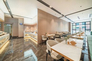 A modern hotel lobby with a marble floor, a breakfast bar, seating area, and large windows. - Poltton International ApartmentsQingyuan (Qingyuan)