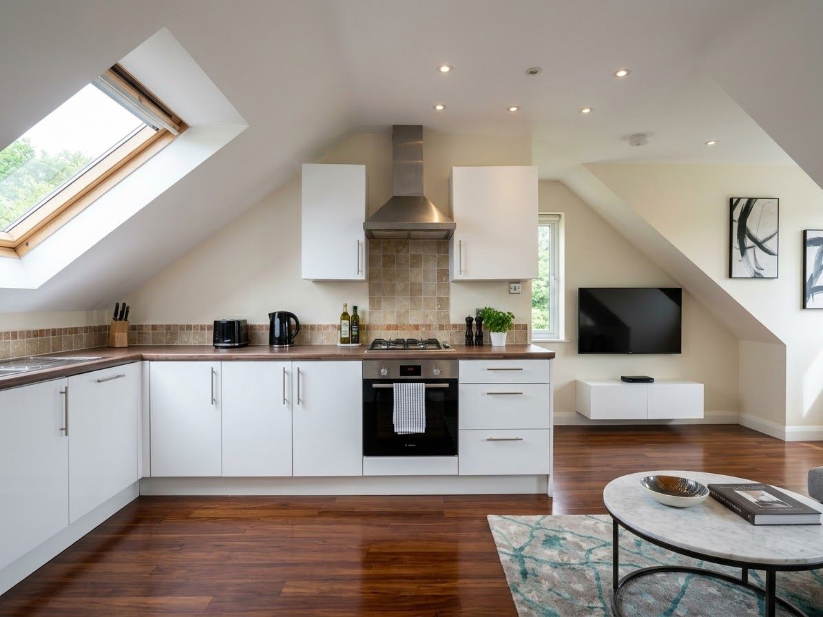 A modern kitchen with white cabinets, a built-in oven, and a gas stove.