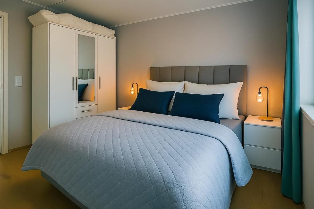 A bedroom with a bed, nightstands, a wardrobe, and a headboard.