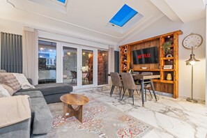 A modern living room with a sofa, coffee table, and dining area. - Willowtree (Liverpool)