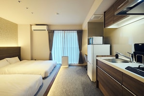 A hotel room with two beds, a kitchenette, a microwave, a refrigerator, and a window with curtains. - HOTEL SOVA Kumamoto Suido-cho (Kumamoto)