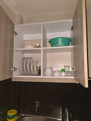 A kitchen with a sink, cabinets, and various kitchenware. - Enjoyable 1-bedroom apartment in lovely Nairobi neighborhood (Nairobi)