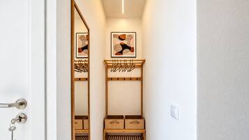 Stylish entryway with full-length mirror, coat rack, and shoe storage
