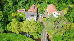 A rural property with two main buildings, a small pond, and a road. - Apartment 'Hohlmühle Vogelsberg Hessen' with Absolute Seclusion, Wi-Fi, Private Terrace & Garden (Feldatal)