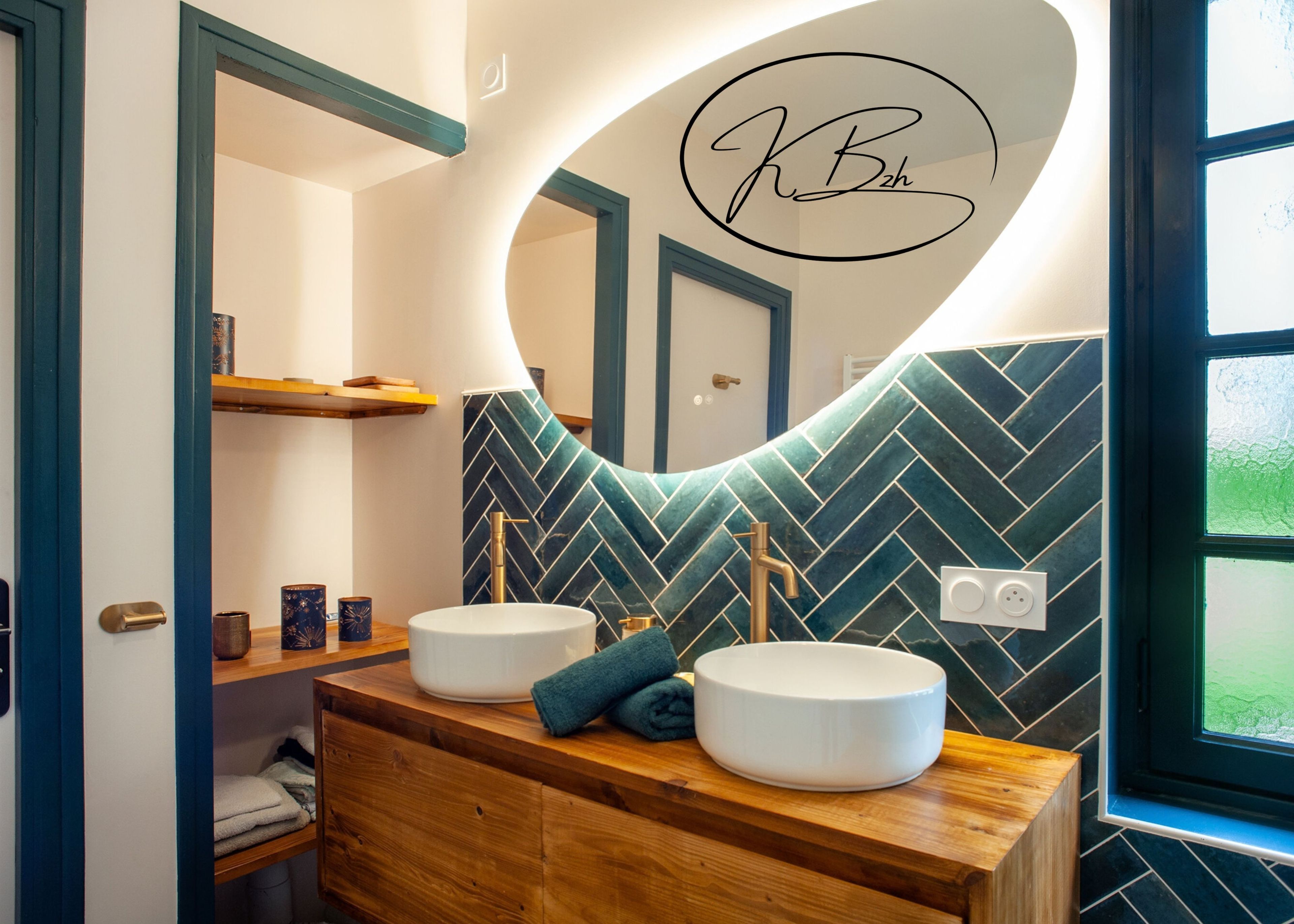 A bathroom with two sinks, a mirror, and a herringbone-patterned wall.
