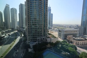 A high-rise building with a modern architectural design, surrounded by other high-rise buildings and a clear sky. - Elegant 1BR apartment in Burj Vista, steps to Iconic Burj Khalifa and Dubai Mall (Dubai)