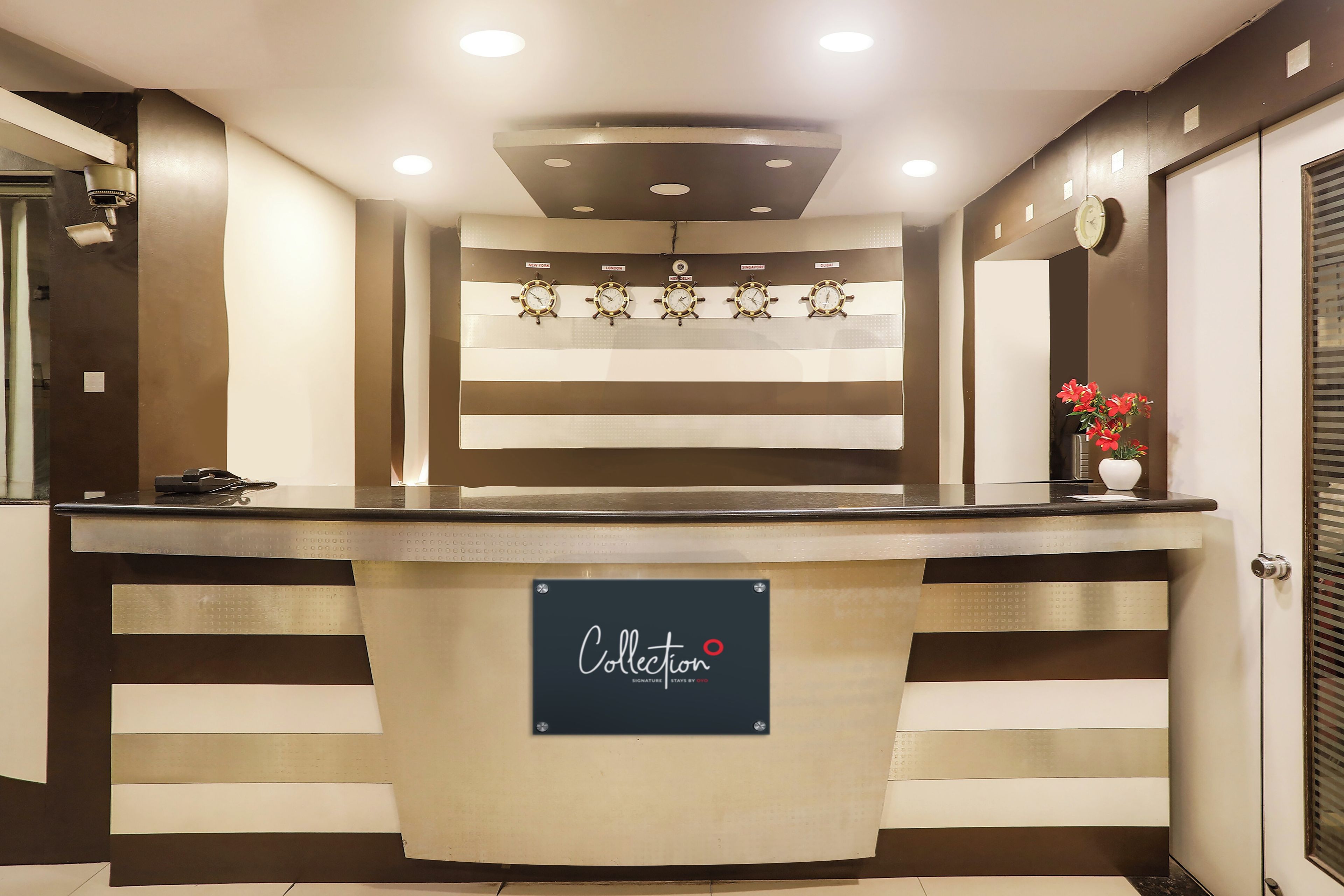 A reception desk with a sign reading 'Collection Signature Stays by CHTG.'