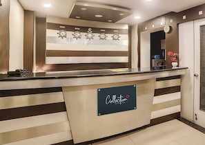A hotel reception desk with a sign indicating a signature collection point. - Super Capital O Prestige (Hyderabad)