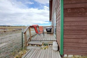 A wooden deck with outdoor seating and a white toilet. - Walkable Fairplay Home w/ Mtn Views! (Fairplay)