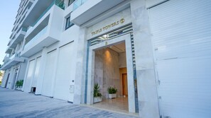 A modern building with a storefront labeled 'TRIPLE TOWERS.' - New, luxury apartment near the TGV station (Tanger)