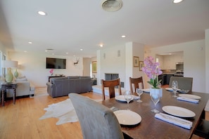 A dining area with a table set for four, a sofa, and a television in the background. - 2 Boat Docks! Marble Falls Lake Retreat (Marble Falls)