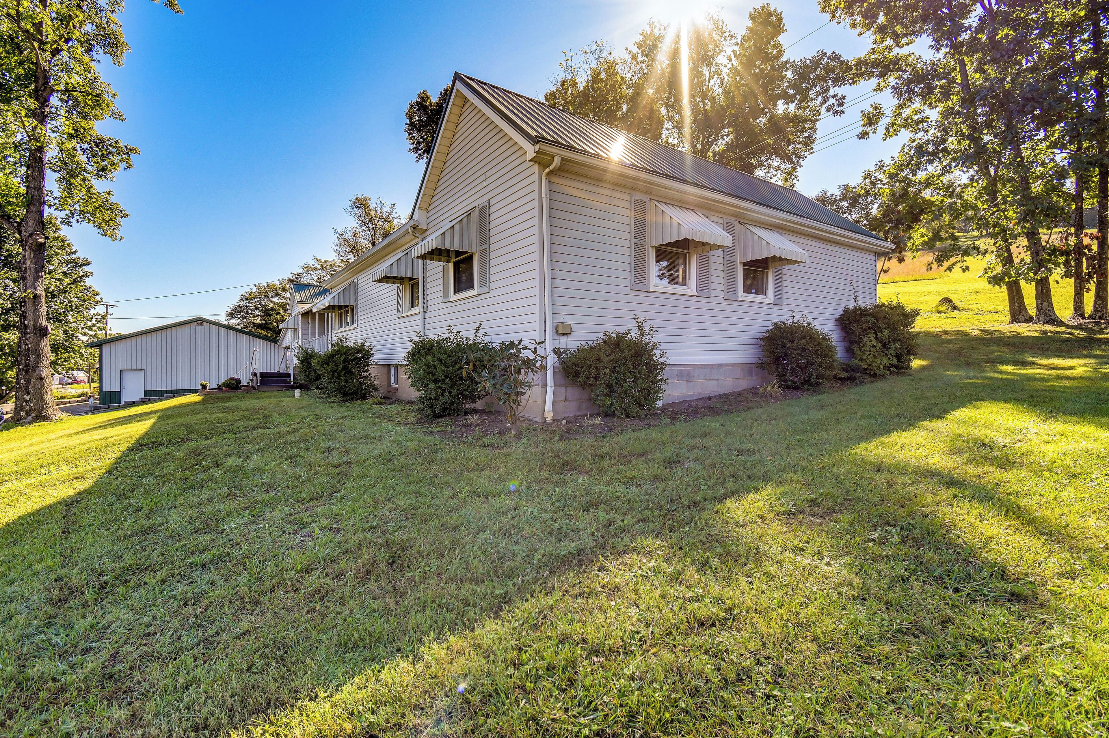 A single-story house with a gabled roof, a front porch, and a small front yard.