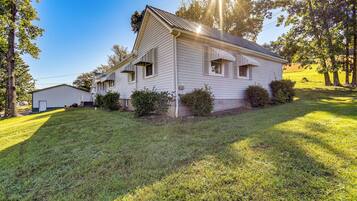 A single-story house with a gabled roof, a front porch, and a small front yard.
