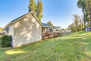 A row of single-story cabins with a wooden deck and a covered outdoor area.