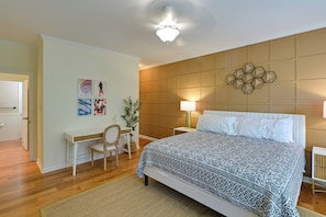 A bedroom with a bed, a desk, a chair, a lamp, and a wall-mounted decorative piece. - Rehoboth Beach Group Getaway! 5 Mi to Boardwalk (Rehoboth Beach)