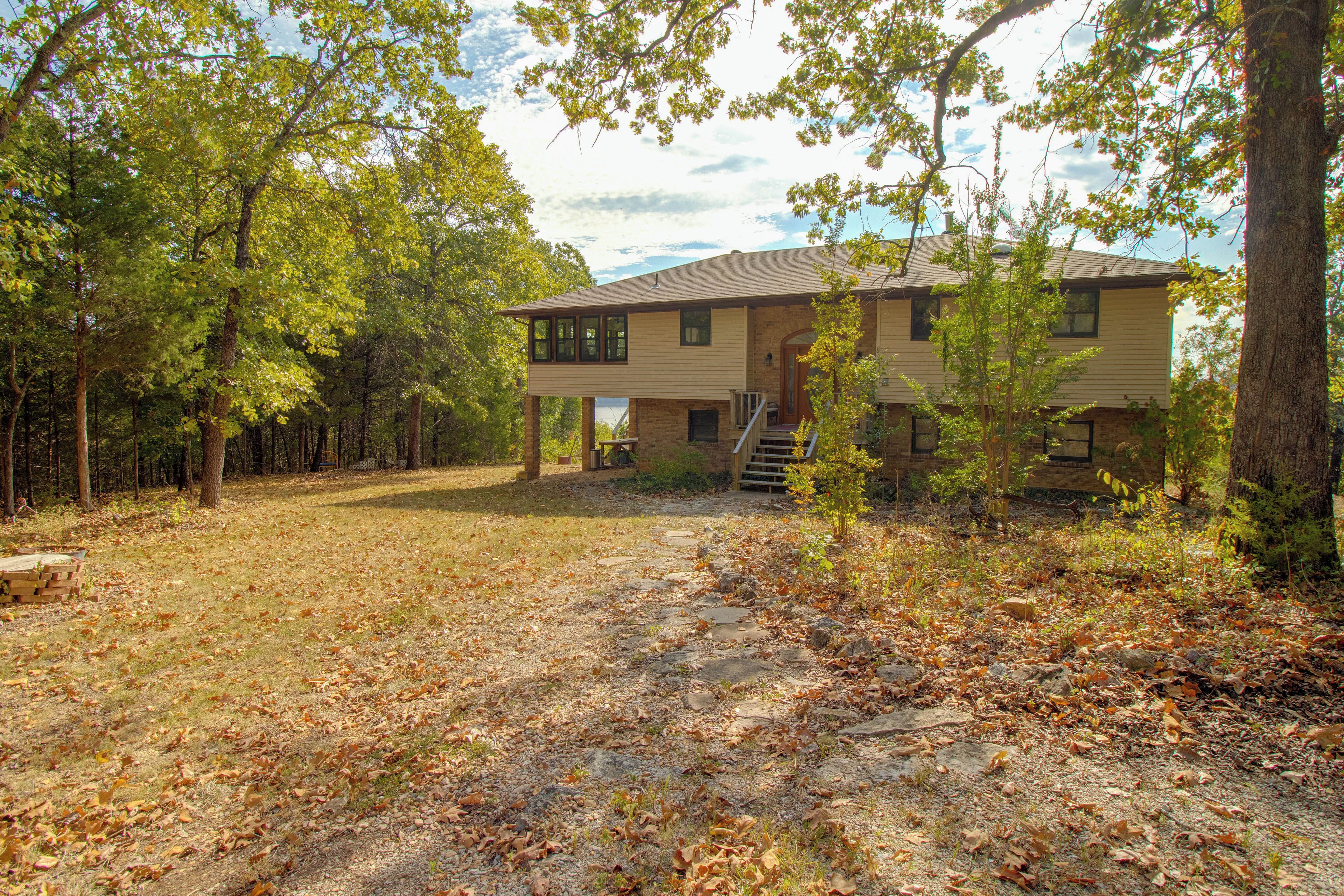 A two-story house with a front porch and a covered outdoor area.
