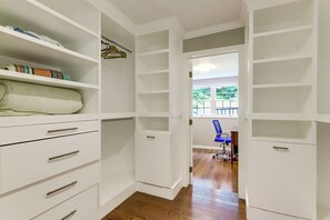 A walk-in closet with open doors, wooden flooring, and a blue chair in the background. - 3 Mi to Wadsworth Falls! Retreat w/ Backyard Oasis (Middletown)