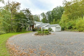 A two-story house with a gravel driveway and a well-maintained lawn. - 3 Mi to Wadsworth Falls! Retreat w/ Backyard Oasis (Middletown)