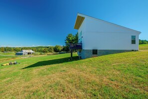 A large white building with a flat roof, situated on a grassy hill. - Hike, Explore & Unwind: Scenic Blue Ridge Escape (Floyd)
