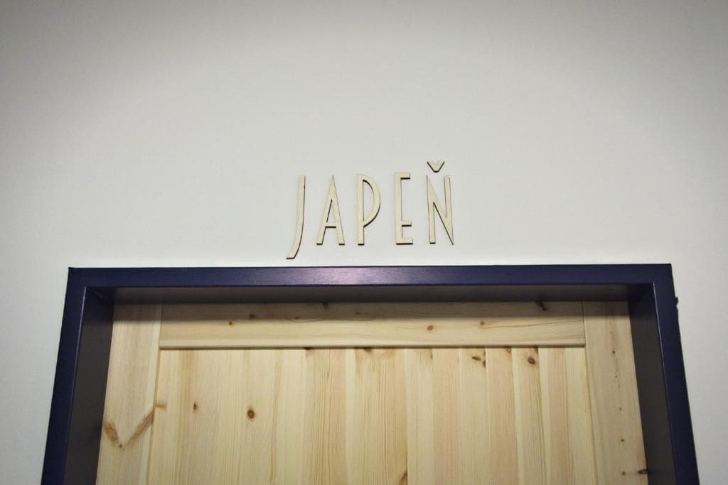 A wooden door with the word 'JAPEN' above it.