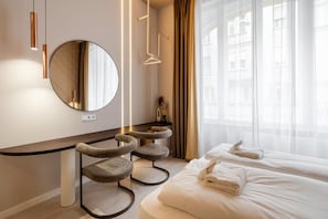 A hotel room with a bed, a round mirror, a cat tree, and a window with curtains. - W18 by BQA (Budapest)