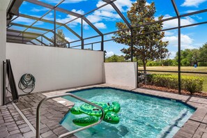 A swimming pool with a clear blue sky and a tree in the background. - NEW 3BR Private Pool Mickey Room Air Hockey (Davenport)