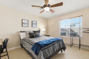 A bedroom with a bed, a desk, a chair, a ceiling fan, and a window with blinds. - Amazing Desert Retreat w/Saltwater Pool! (Phoenix)