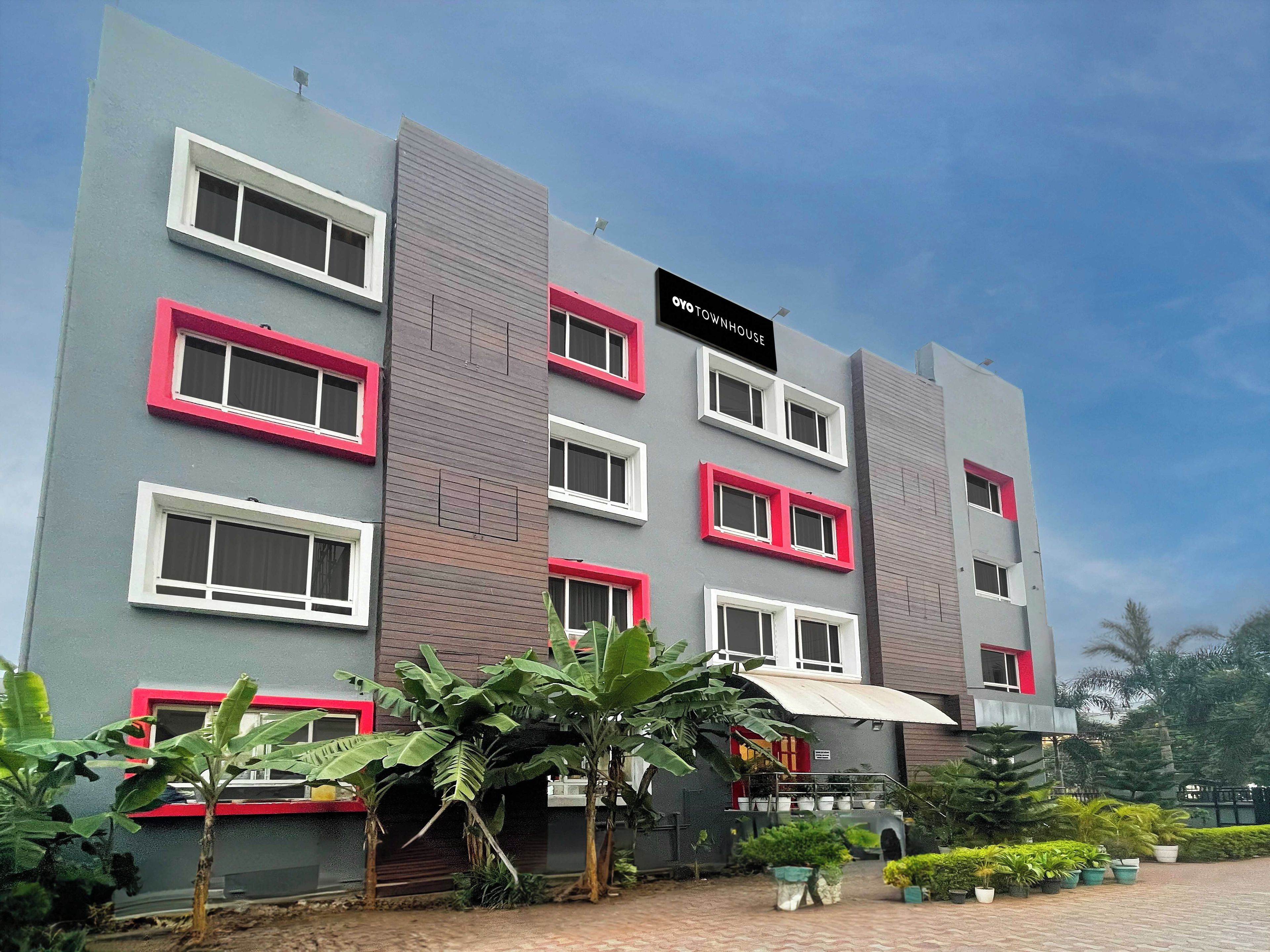 A multi-story building with a sign reading 'OYO TOWNHOUSE'.