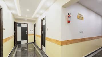 A hotel corridor with doors numbered 503 and 501, a fire extinguisher, and a no smoking sign on the wall.