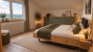 A bedroom with a bed, bedside tables, a window with a view, and a headboard with wall-mounted lamps.