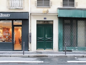 A storefront with a sign reading 'Beauty' and a green door with a number '2' above it. - A cozy Paris — 2-minute walk from the metro (Paris)